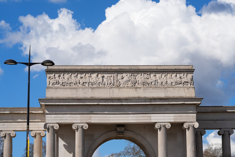 a stone arch with a sky in the background