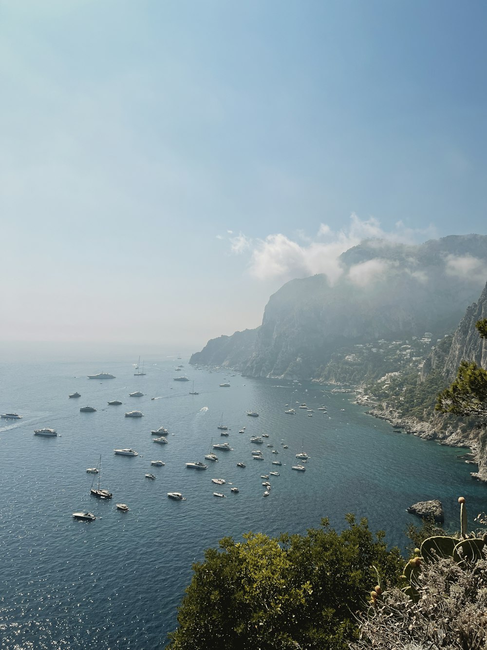 a group of boats floating on top of a large body of water