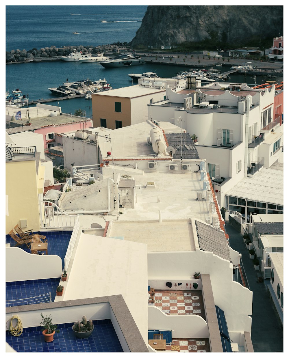 an aerial view of a city with boats in the water