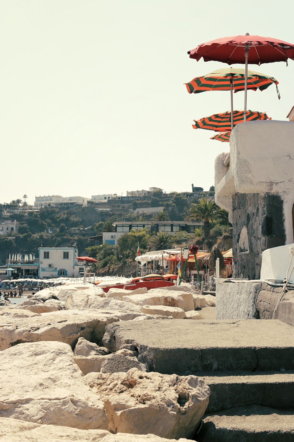 a beach with a bunch of umbrellas on top of it