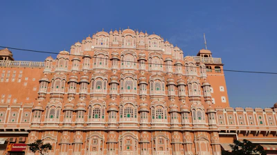 Elegant Jaipur villa with traditional jaali windows and a lush courtyard.