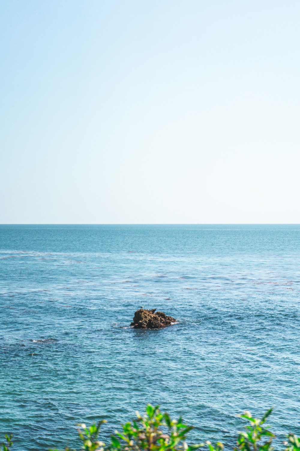 a lone rock in the middle of the ocean