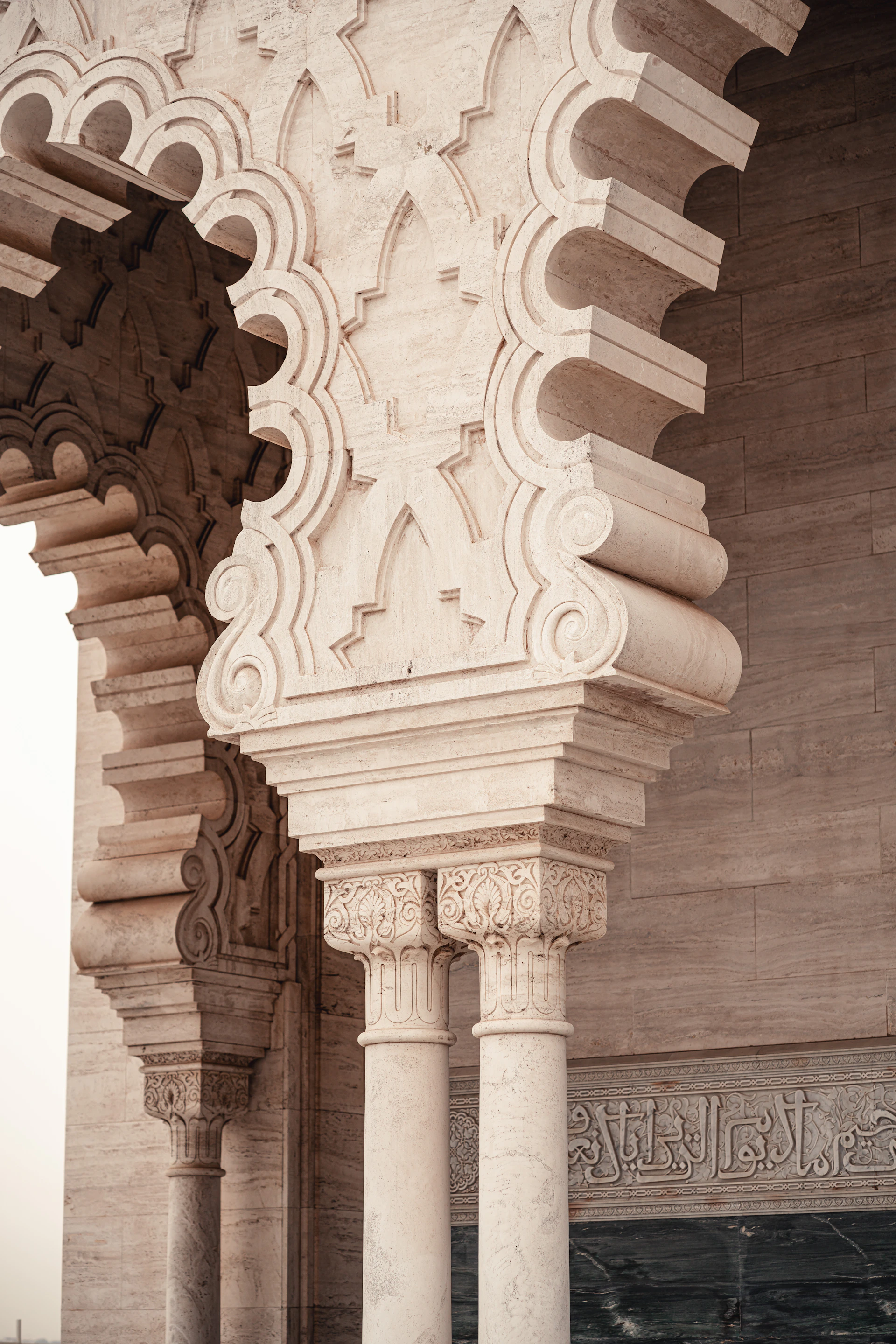 a tall white building with columns and a clock