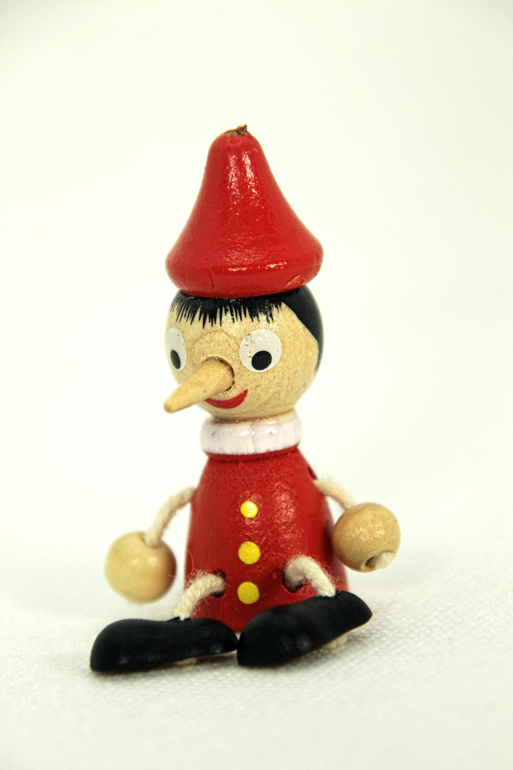 a toy figurine of a boy with a red hat