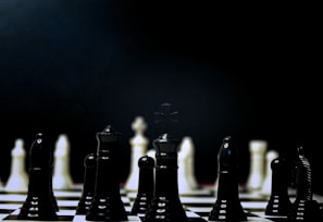 a black and white chess board with pieces on it
