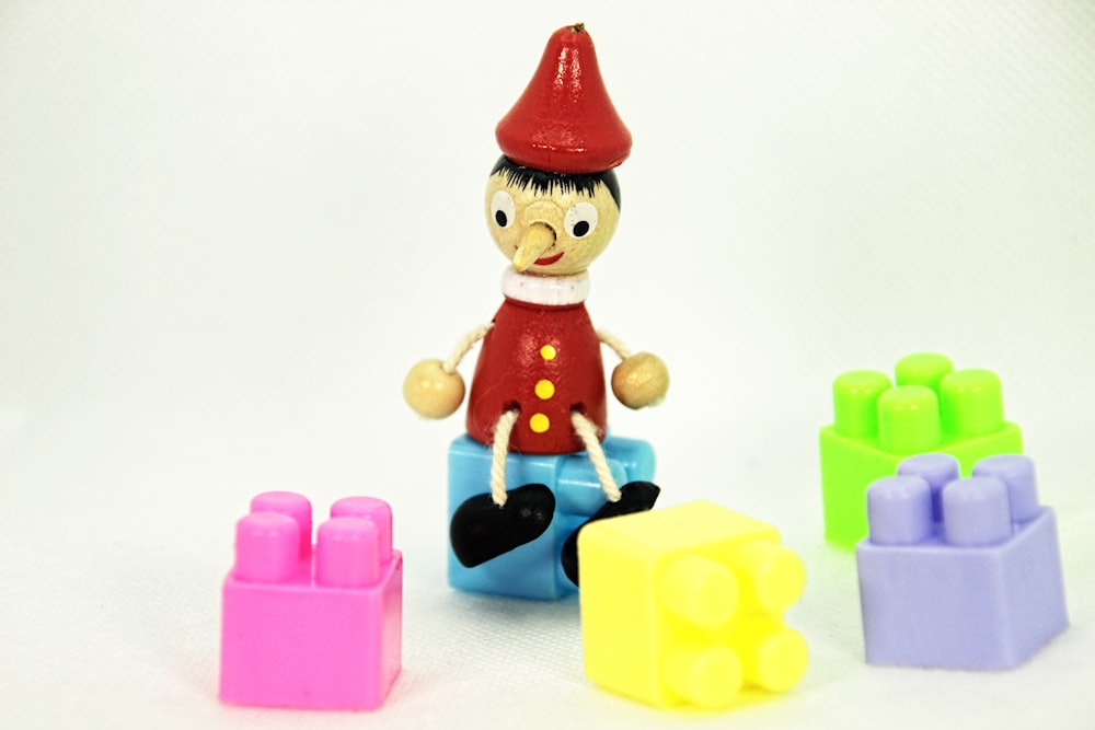 a small toy with a red hat and a red shirt