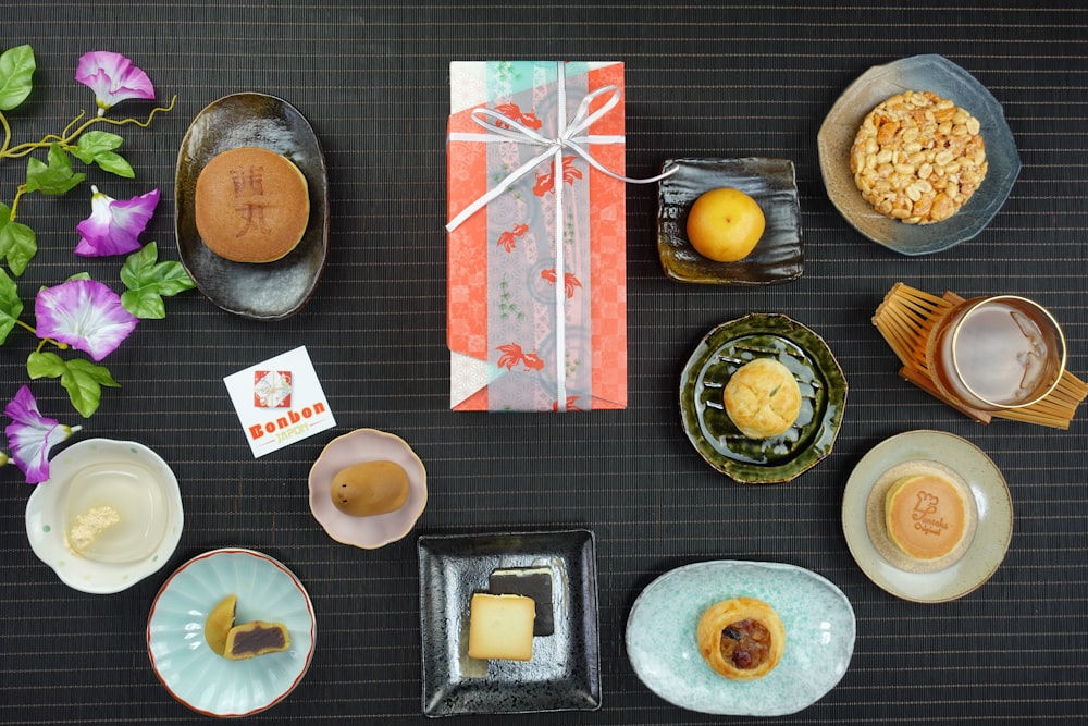 a table topped with plates and bowls filled with food