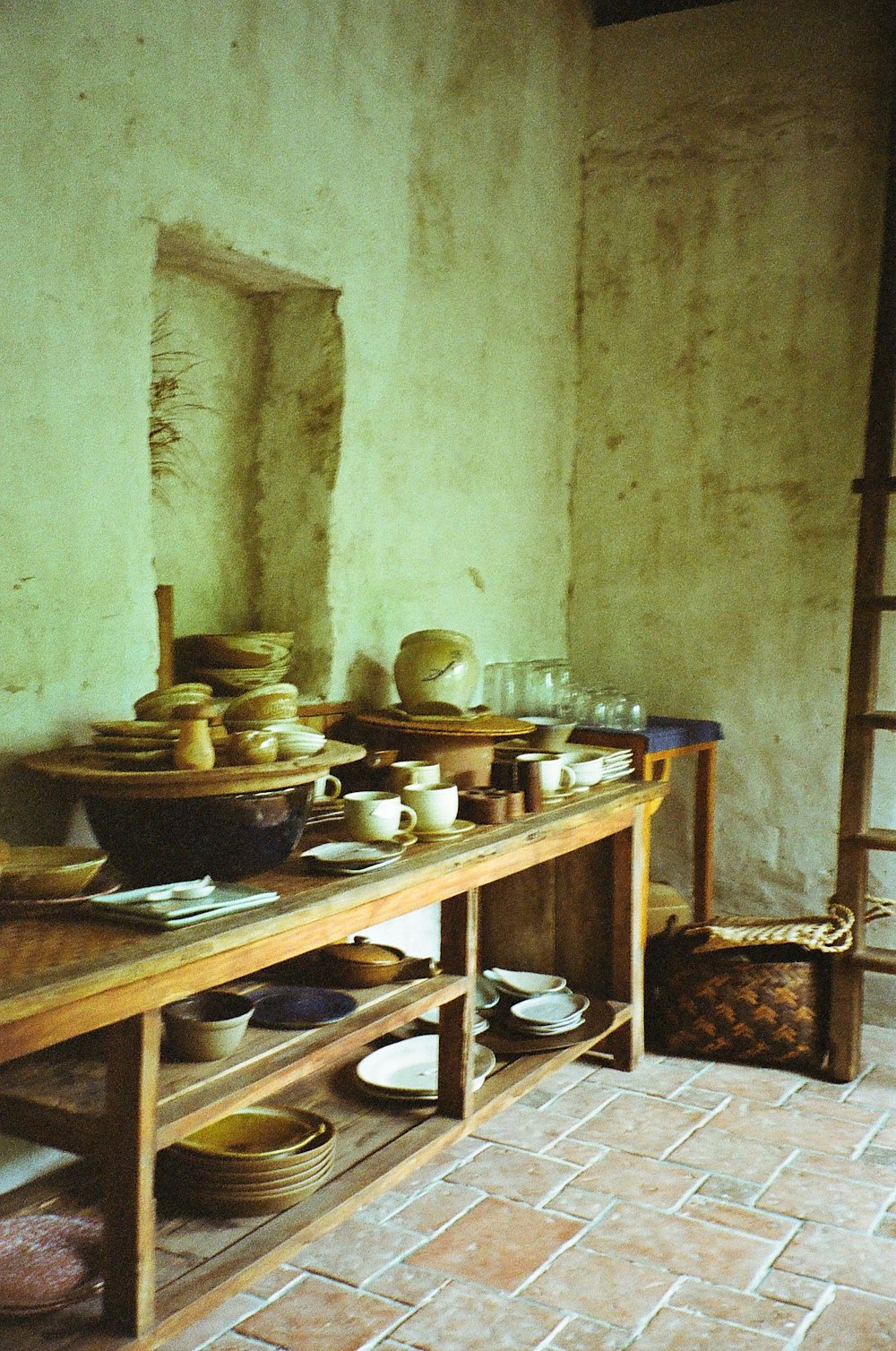 a wooden table topped with bowls and plates