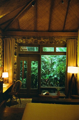 Cozy and bright homestay room with natural light and view of lush greenery at Duy Cảnh Homestay.