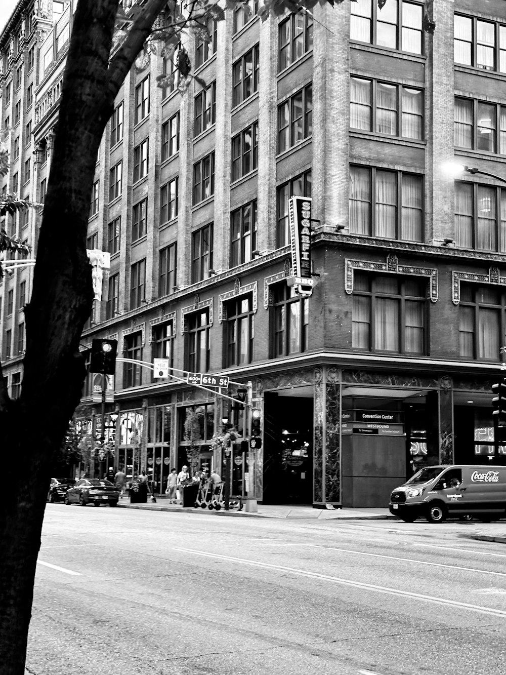 a black and white photo of a street corner