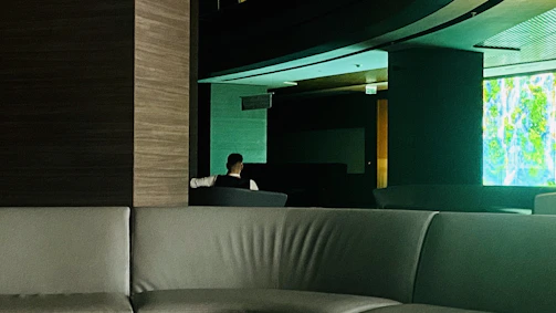 A sleek, dark interior shot showing intimate seating with subtle lighting highlighting minimalist decor.