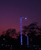 Technicians installing energy-efficient LED streetlights in a residential neighborhood at dusk.