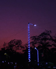 Technicians installing energy-efficient LED streetlights at dusk.