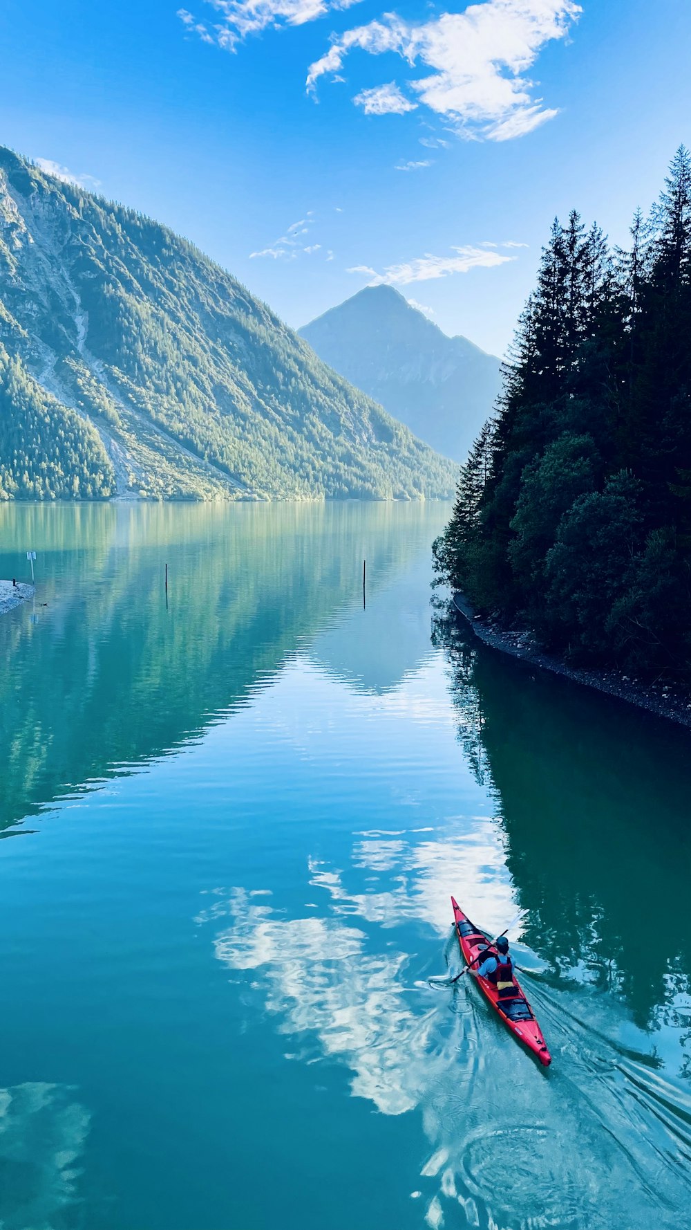 a person in a kayak on a calm lake