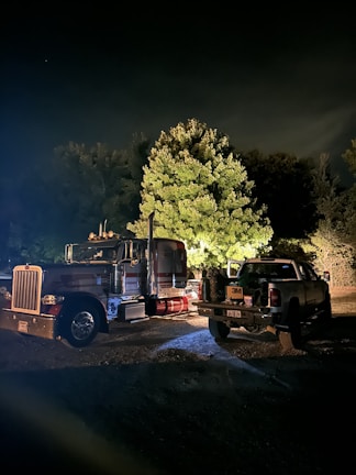 A nighttime shot of a Sugo Logistic truck illuminated by streetlights, ready for a long haul.