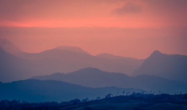 A serene digital landscape featuring a glowing sunset over rolling hills