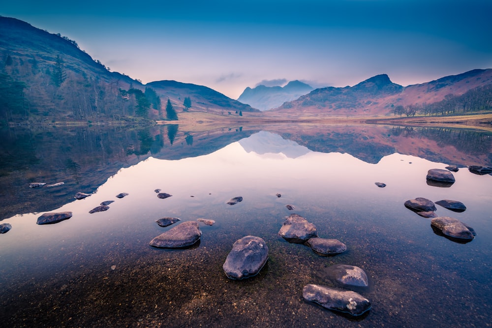 a body of water surrounded by mountains and rocks