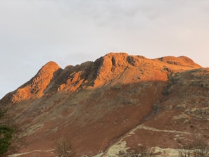 Wide-angle view of foothills bathed in warm sunlight highlighting natural contours