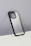 A smartphone case with a sleek, semi-transparent back featuring curvy line patterns. The case has a black border and is displayed against a plain, grayish wall with a white surface at the bottom.