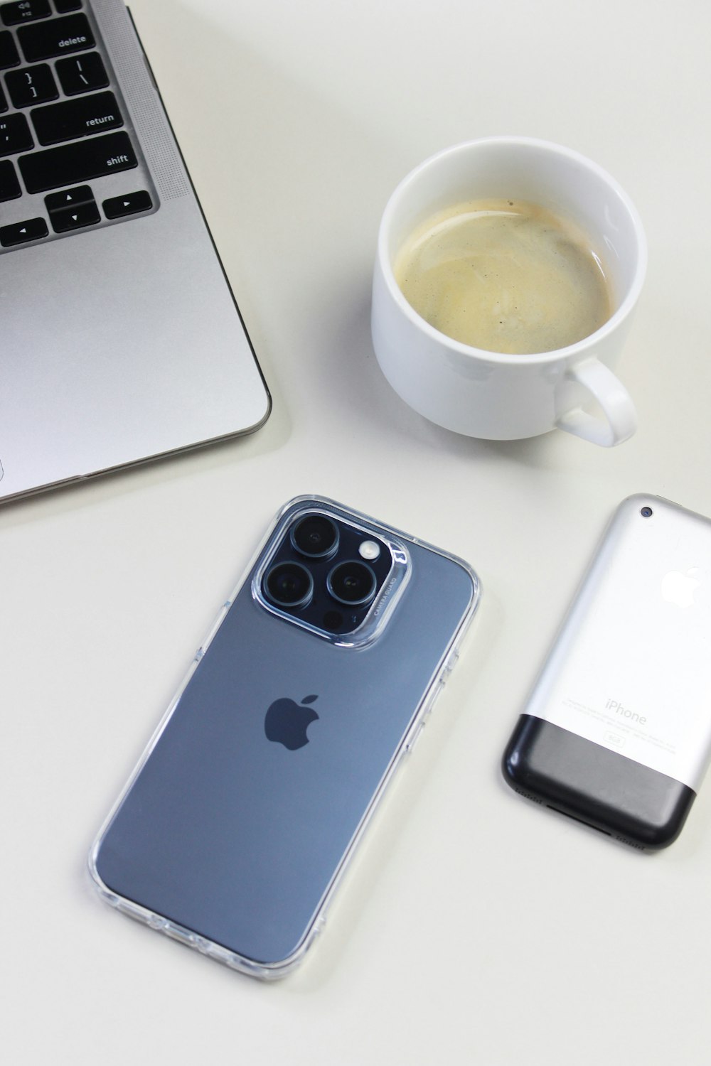 a cup of coffee and a cell phone on a table