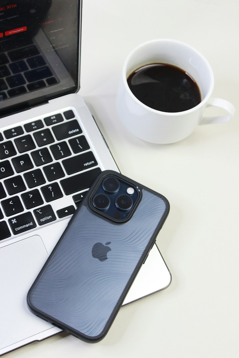 a laptop computer sitting next to a cup of coffee