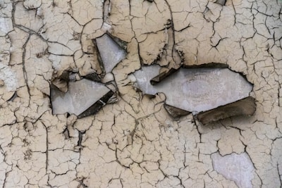 Close-up of a cracked wall showing detailed fissures before repair.