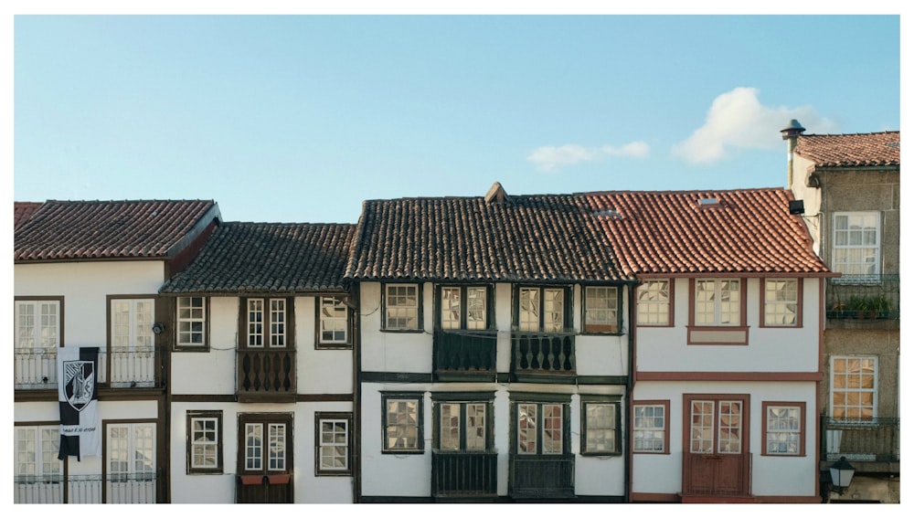 a row of multi - colored buildings with a blue sky in the background