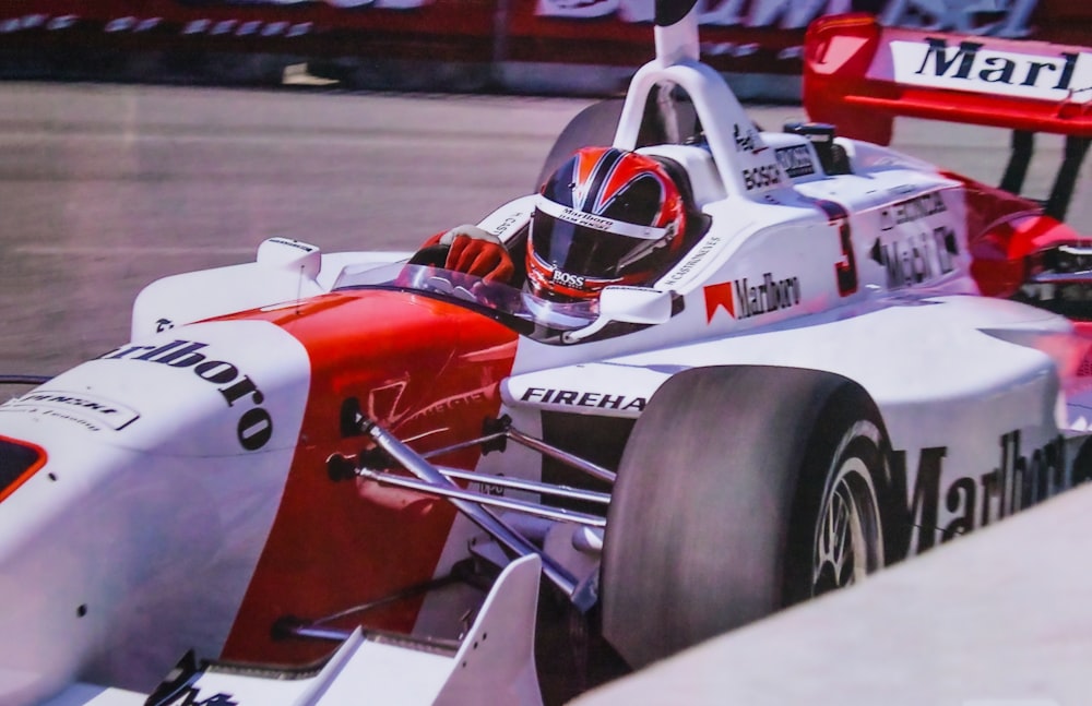 a man driving a race car on a track