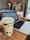 A close-up of a person typing on a laptop with a coffee cup beside them.