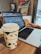 Close-up of hands browsing products on a laptop with a coffee cup nearby.