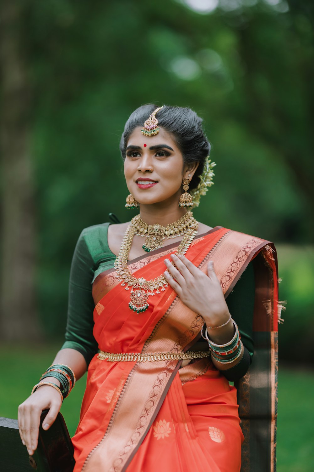 a woman in an orange and green sari
