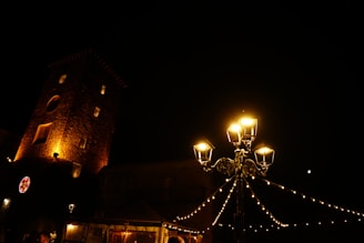 Ivory-hued ruin backdrop with delicate electric string lights glowing softly at dusk