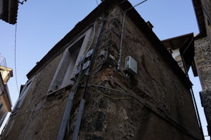 Electrician testing a circuit breaker in a rustic farm building