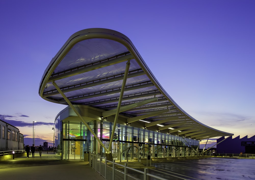 a building with a curved roof and a walkway leading up to it