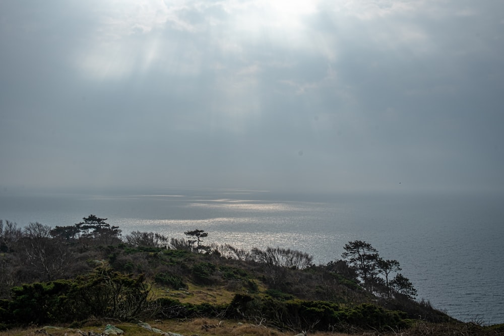 the sun shines through the clouds over the ocean