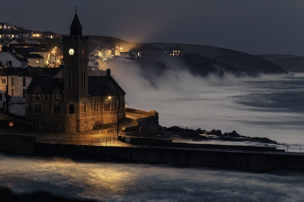 a night time view of a town by the ocean