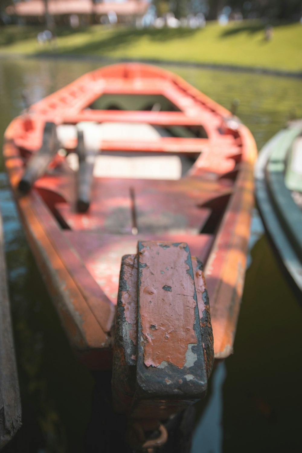 a red boat sitting next to a wooden dock