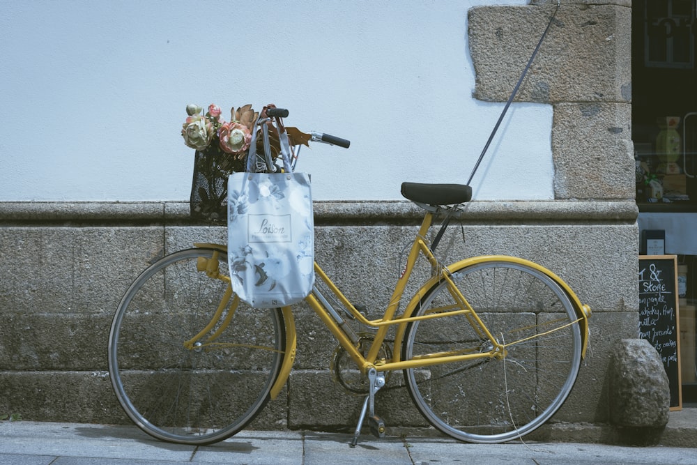 a yellow bike with a white bag on the back