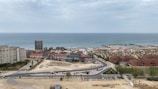 A panoramic view of a new coastal residential development under construction with ocean in the background
