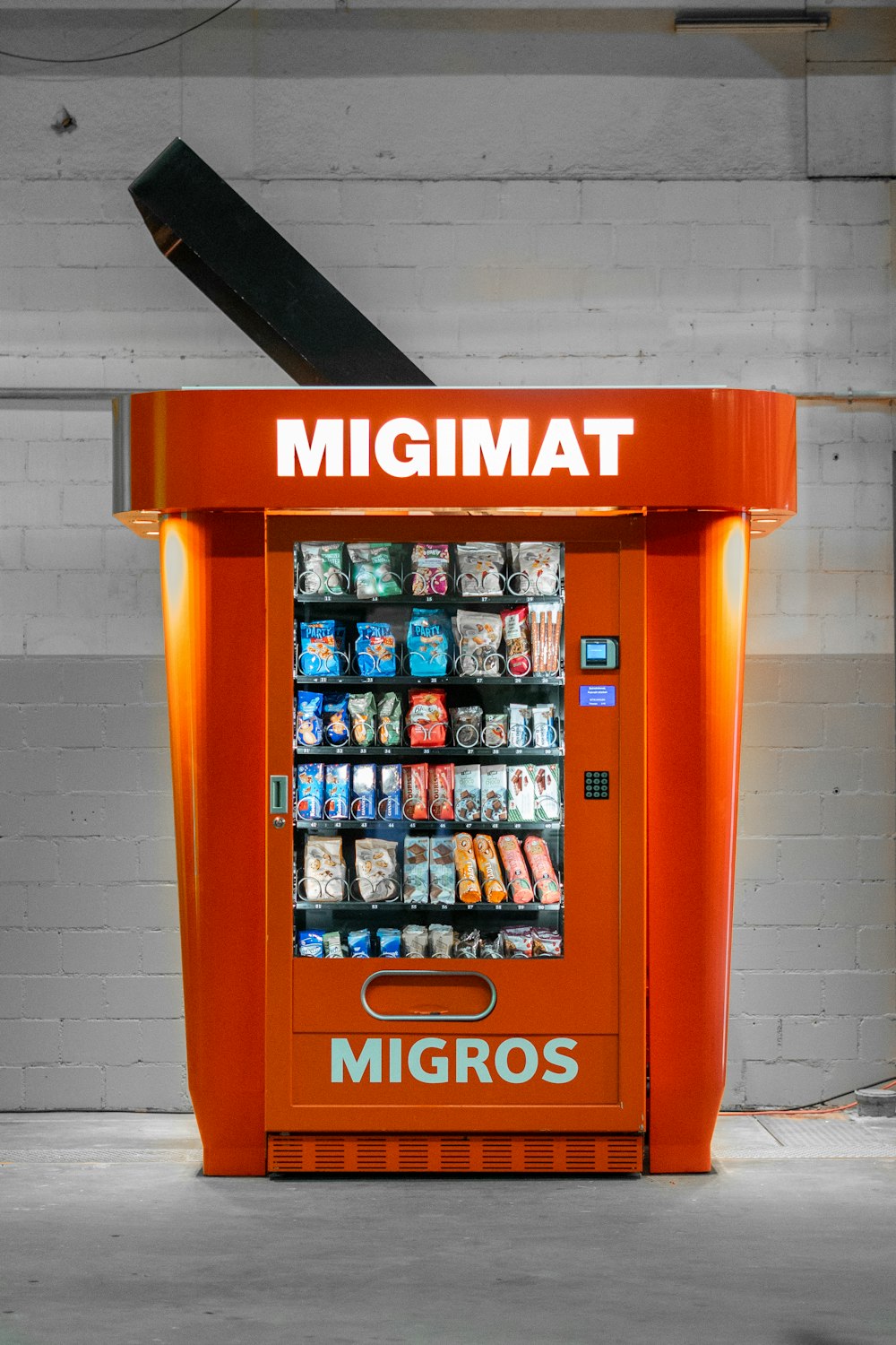 an orange machine with a large amount of food inside of it
