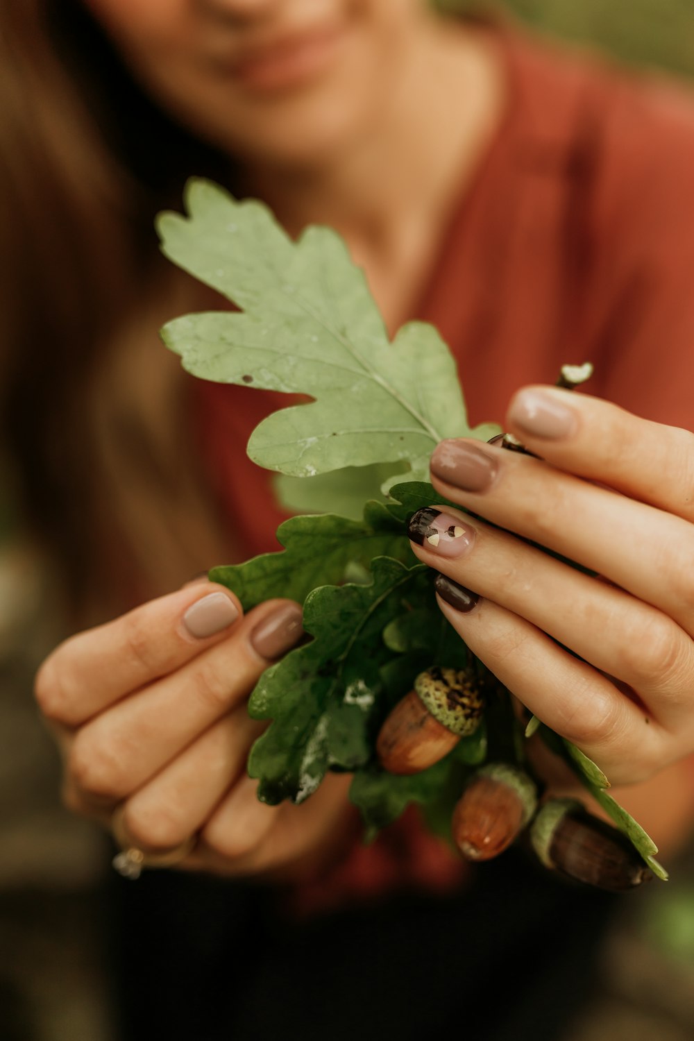 a close up of a person holding a leaf