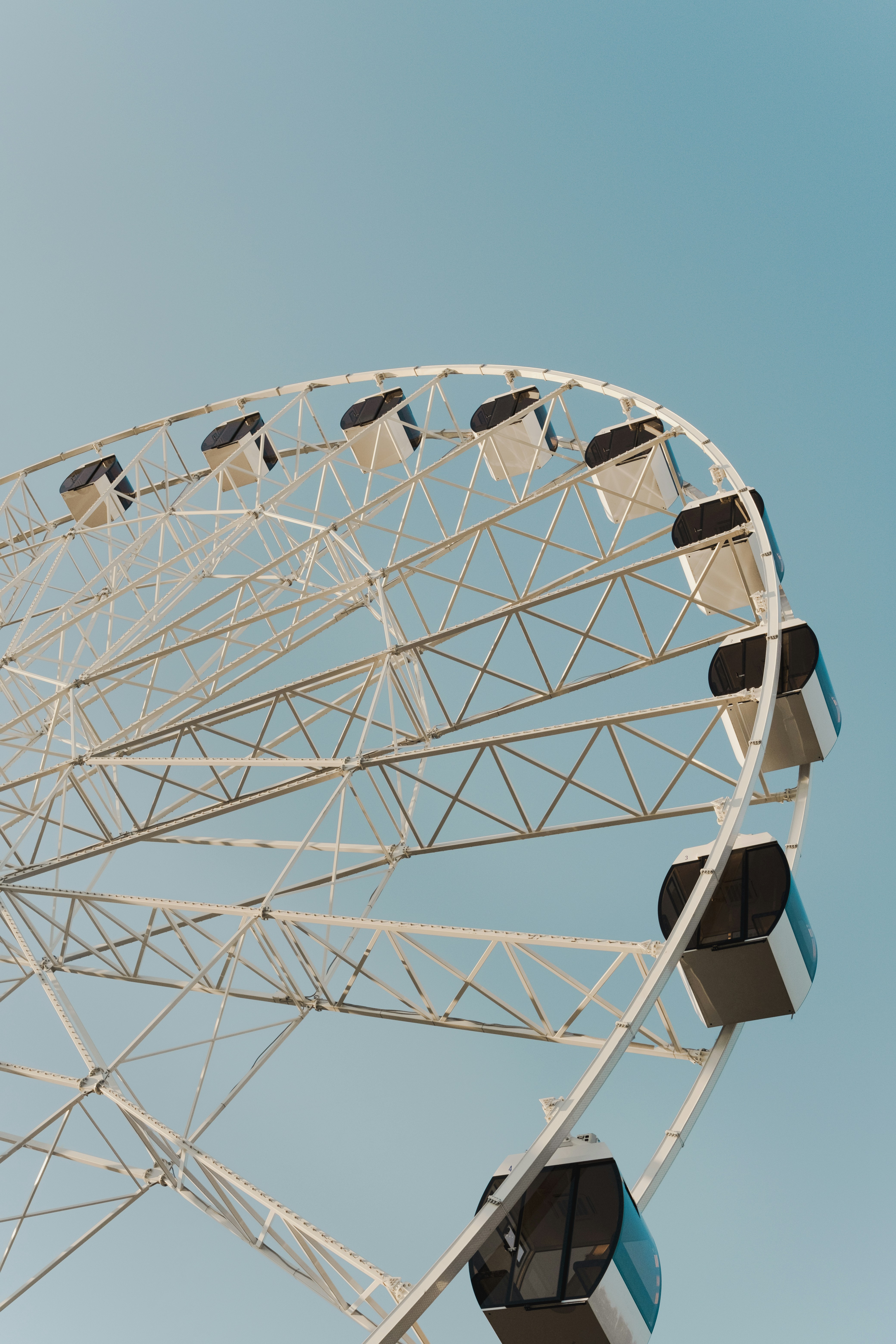 a large white ferris wheel against a blue sky