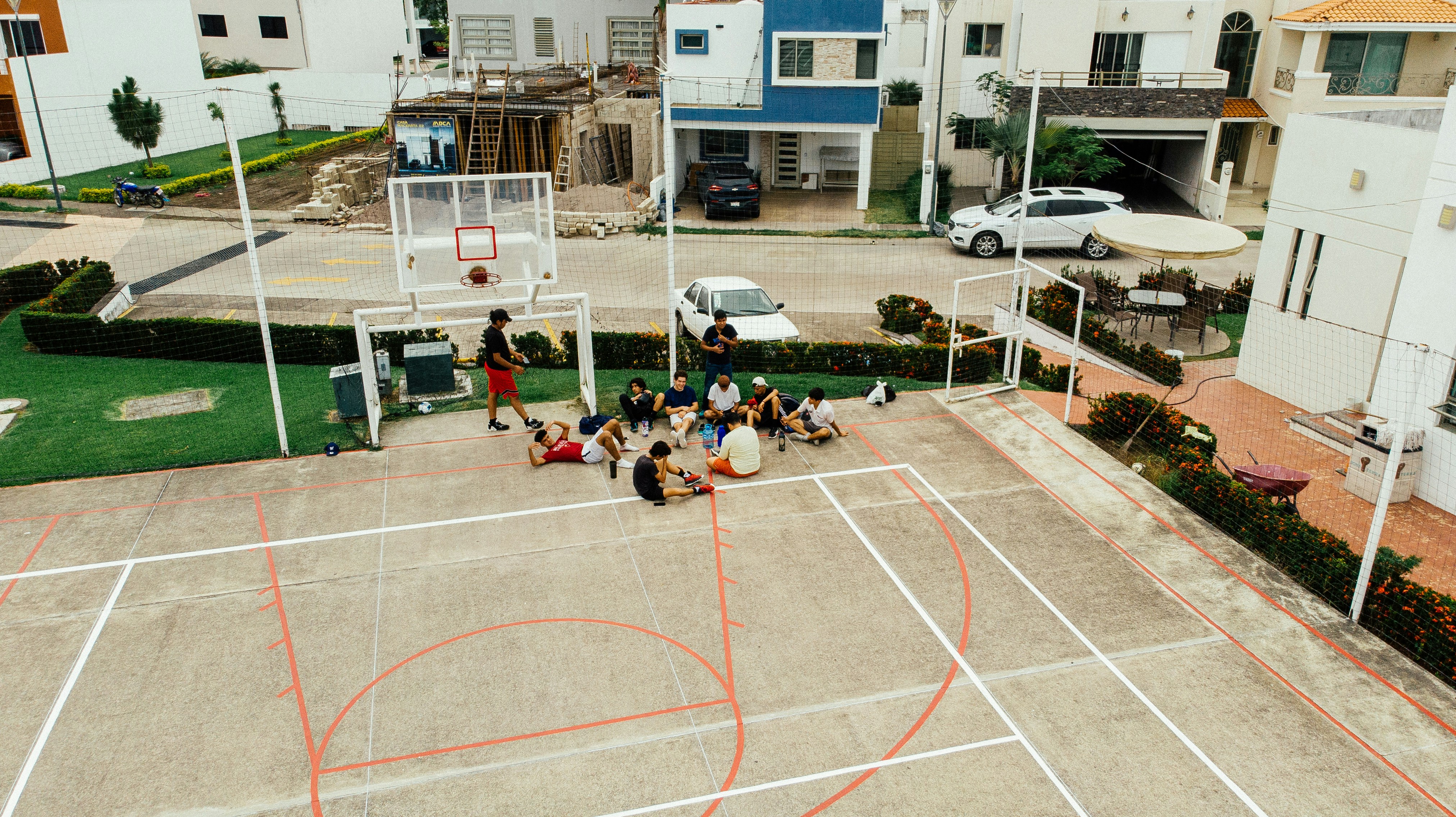 a group of people sitting around a basketball court