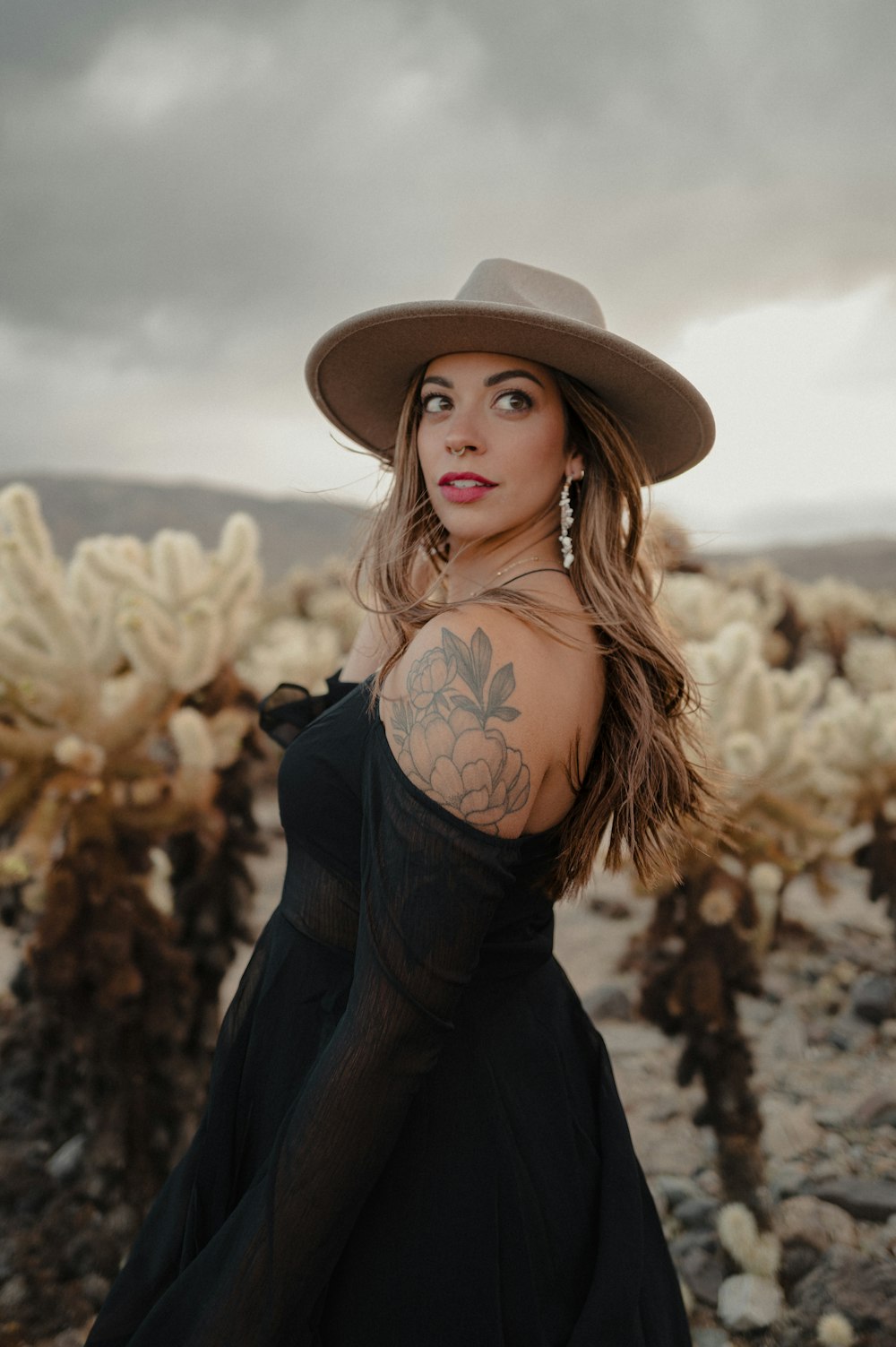 a woman wearing a hat and a black dress