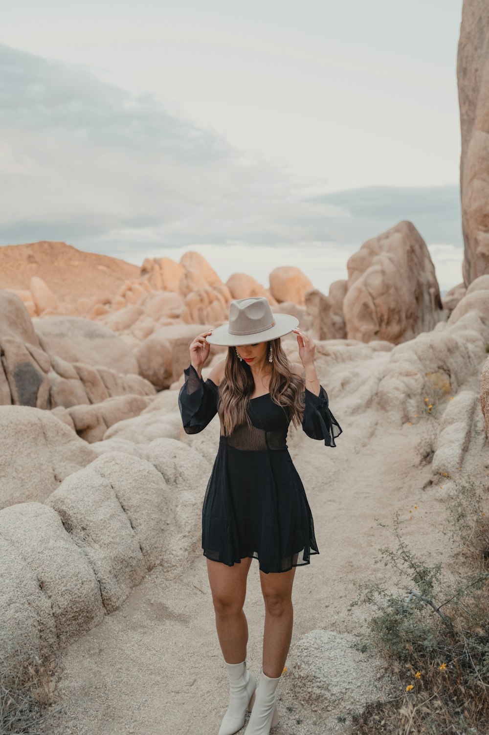 a woman wearing a hat and a black dress