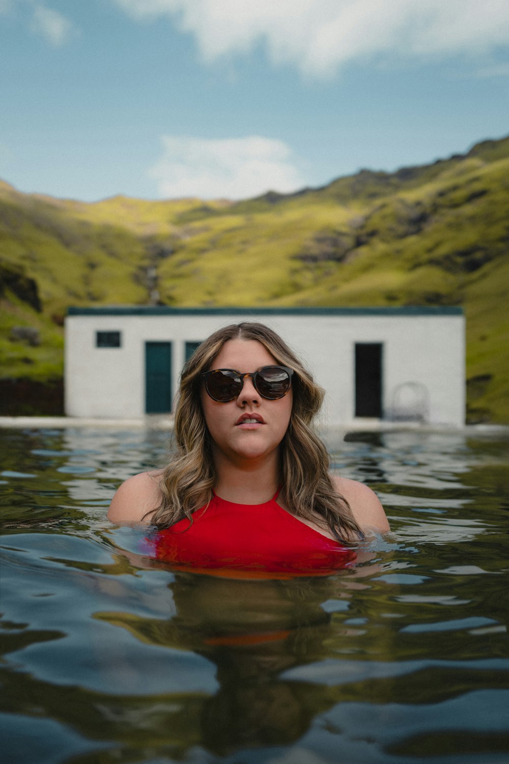 a woman in a red top in a body of water