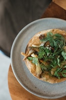 Golden quiche with a flaky crust and fresh herbs on top.