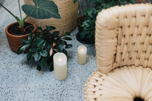 A cozy self-care setup with candles and plants.