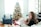 Cozy living room scene with family unwrapping joybox Christmas gift boxes