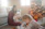 Parents and children enjoying snacks together under festive decorations.